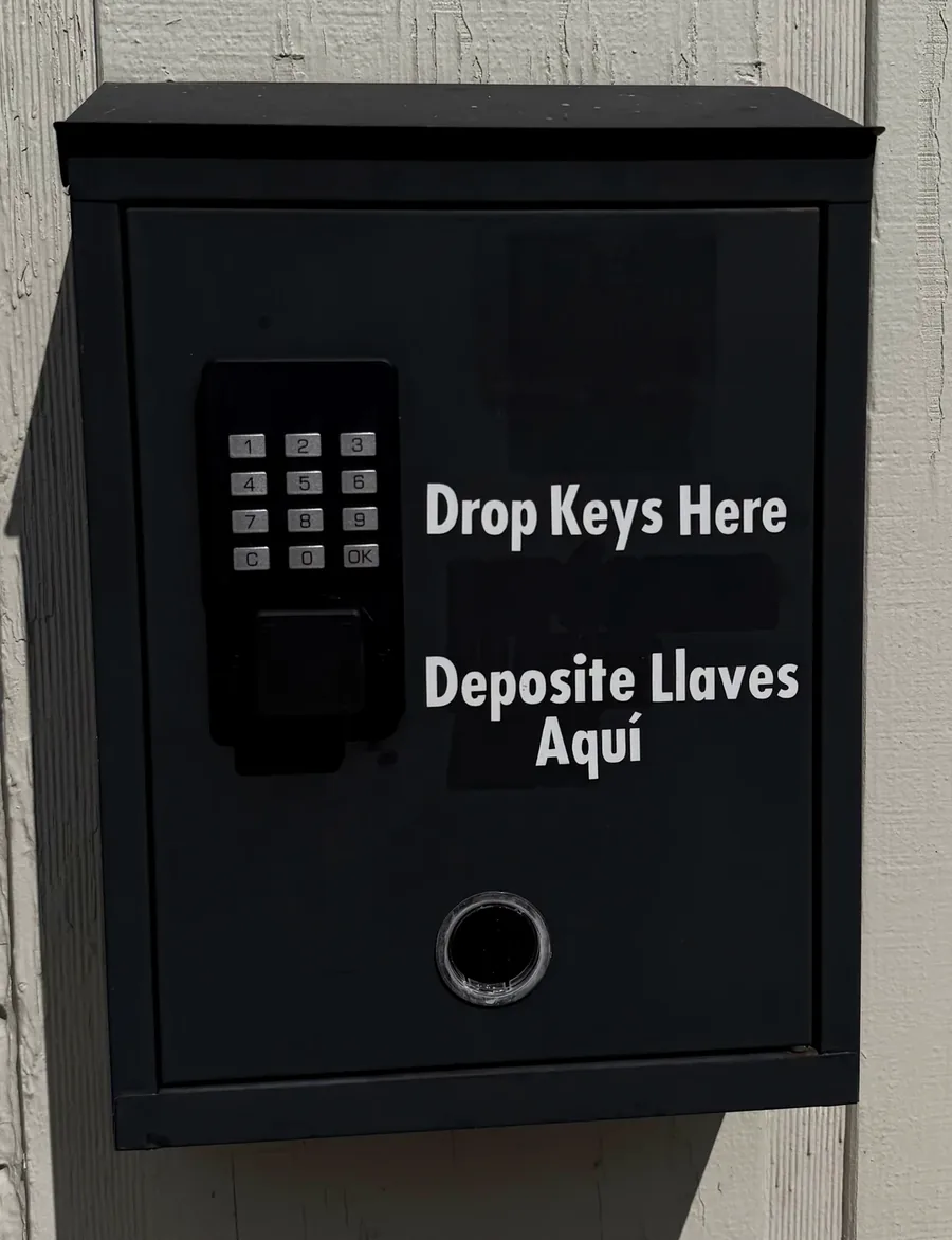 After-hours key drop box at JP Auto Repair, labeled Drop Keys Here and Deposite las llaves aquí