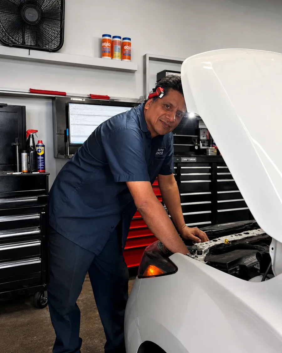 José, the owner of JP Auto Repair, working under the hood